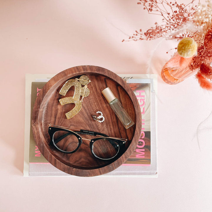 walnut tray catchall on books next to flowers