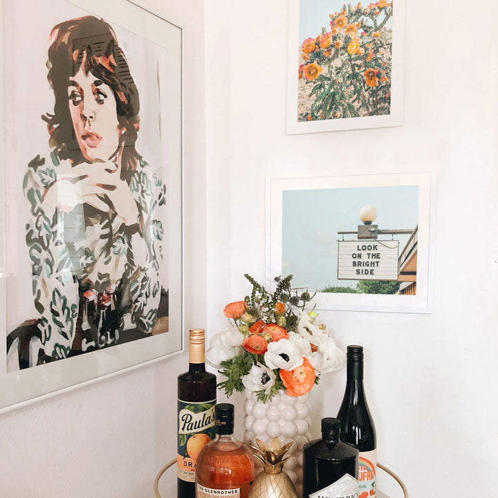 image of austin prints in frames next to a bar cart